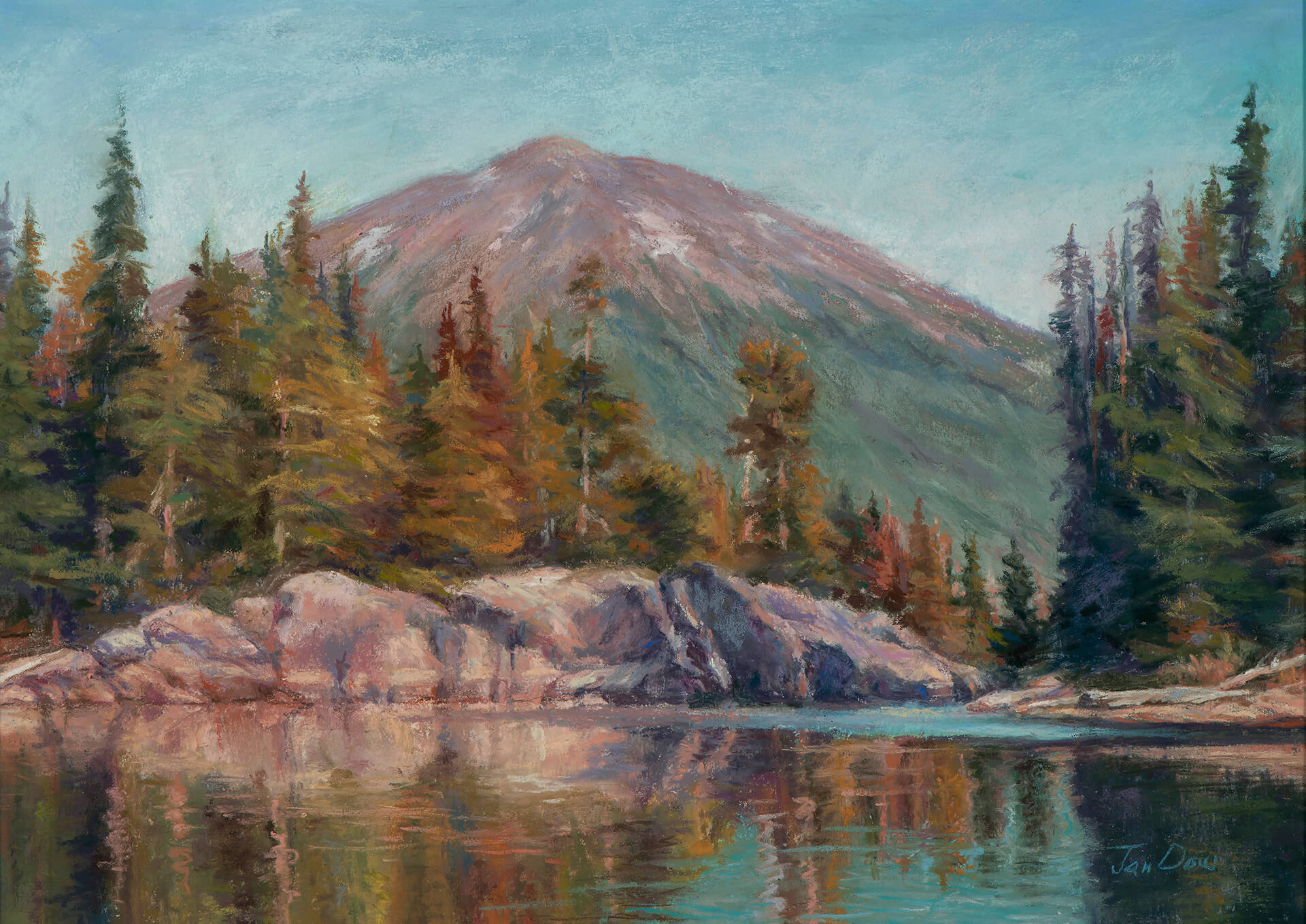 A serene mountain landscape with a calm lake reflecting the surrounding trees and snow-capped peak in Central Oregon.