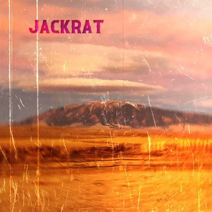 A vast, golden desert landscape under a dramatic, colorful sky in Central Oregon.