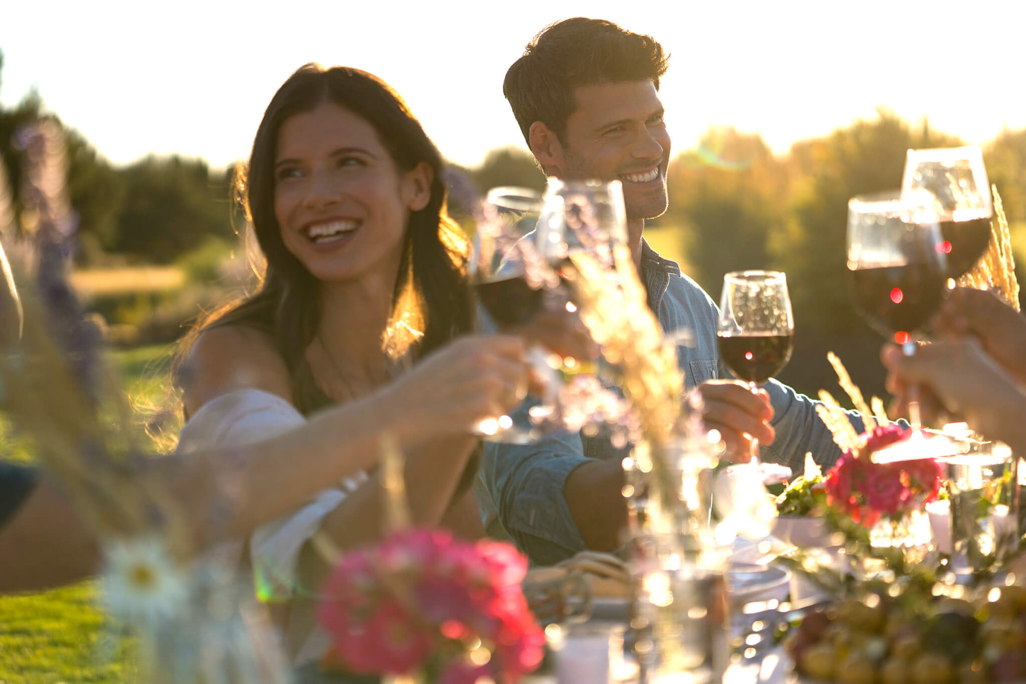 A group of friends enjoying a sunset picnic with wine and laughter in Central Oregon.