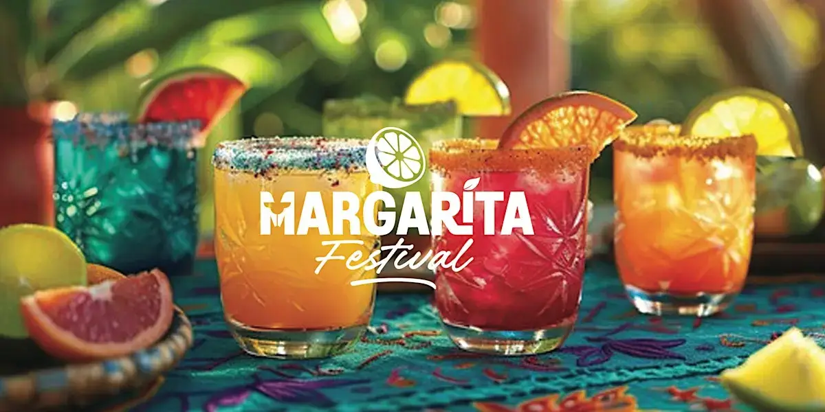 Colorful margaritas with citrus garnishes on a vibrant tablecloth at the Margarita Festival in Central Oregon.