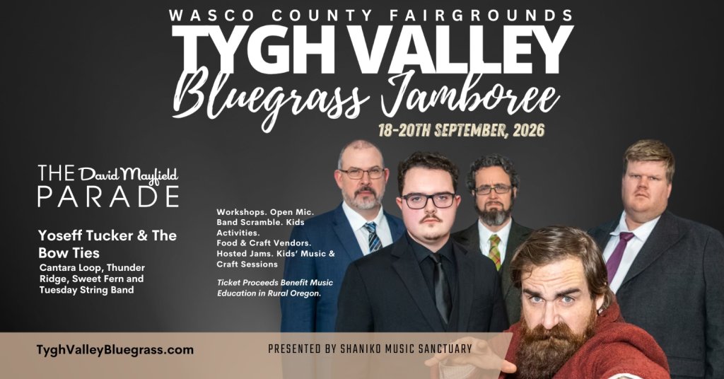 A group of six men dressed in suits and ties, with one man in a red cape and beard, promoting the Tygh Valley Bluegrass Jamboree and Parade in Central Oregon.