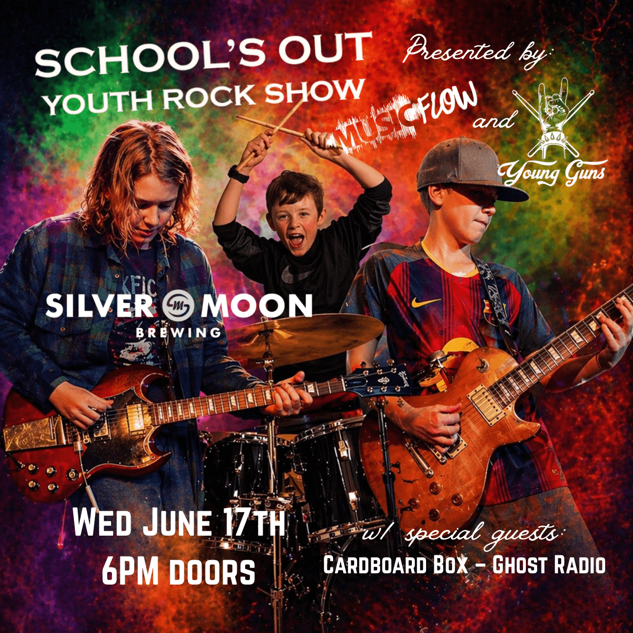 Three young musicians, including a drummer and two guitarists, perform on stage with vibrant, colorful lighting in the background in Central Oregon.