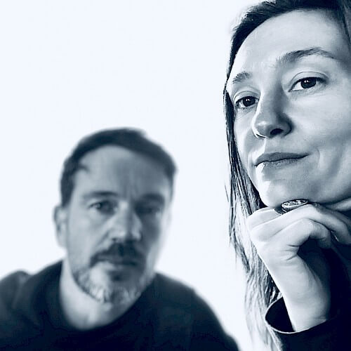 A man and woman in a thoughtful pose, looking towards the camera in Central Oregon.