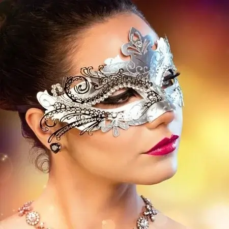 A woman wearing an ornate silver masquerade mask with black accents and jewels in Central Oregon.