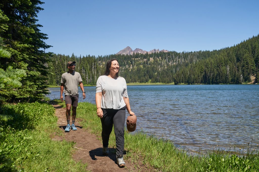 A couple takes a walk around sunny Todd Lake