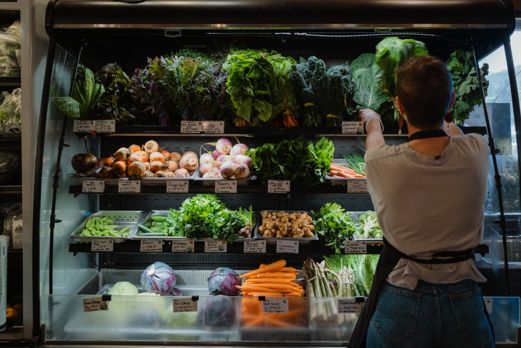 Woman stocking the shelves at Central Oregon Locavore in Bend, Oregon