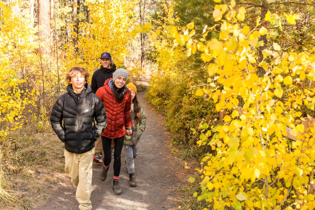 Family walking on a trail in Shevlin Park in Bend, Oregon