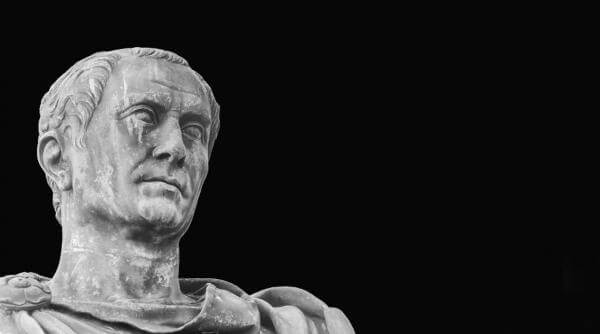A stone bust of Julius Caesar against a solid black background in Central Oregon.