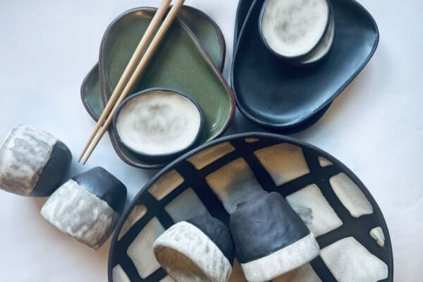 A collection of handmade ceramic plates, bowls, and cups with chopsticks in Central Oregon.