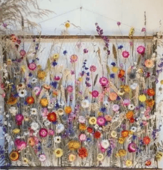 A rectangular wall hanging featuring a vibrant arrangement of dried wildflowers and grasses in Central Oregon.