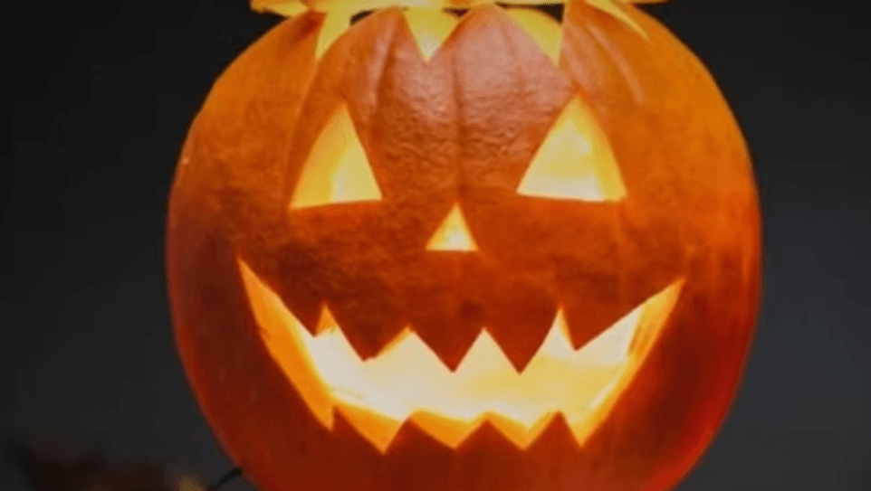 A glowing jack-o'-lantern with a carved face against a dark background in Central Oregon.