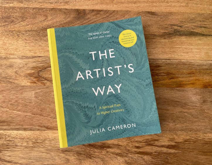 A copy of The Artist's Way book by Julia Cameron on a wooden surface in Central Oregon.