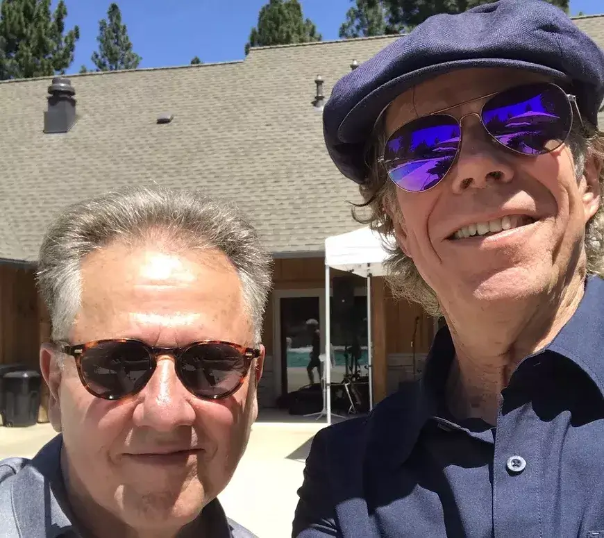 Two men wearing sunglasses pose for a selfie outdoors on a sunny day in Central Oregon.
