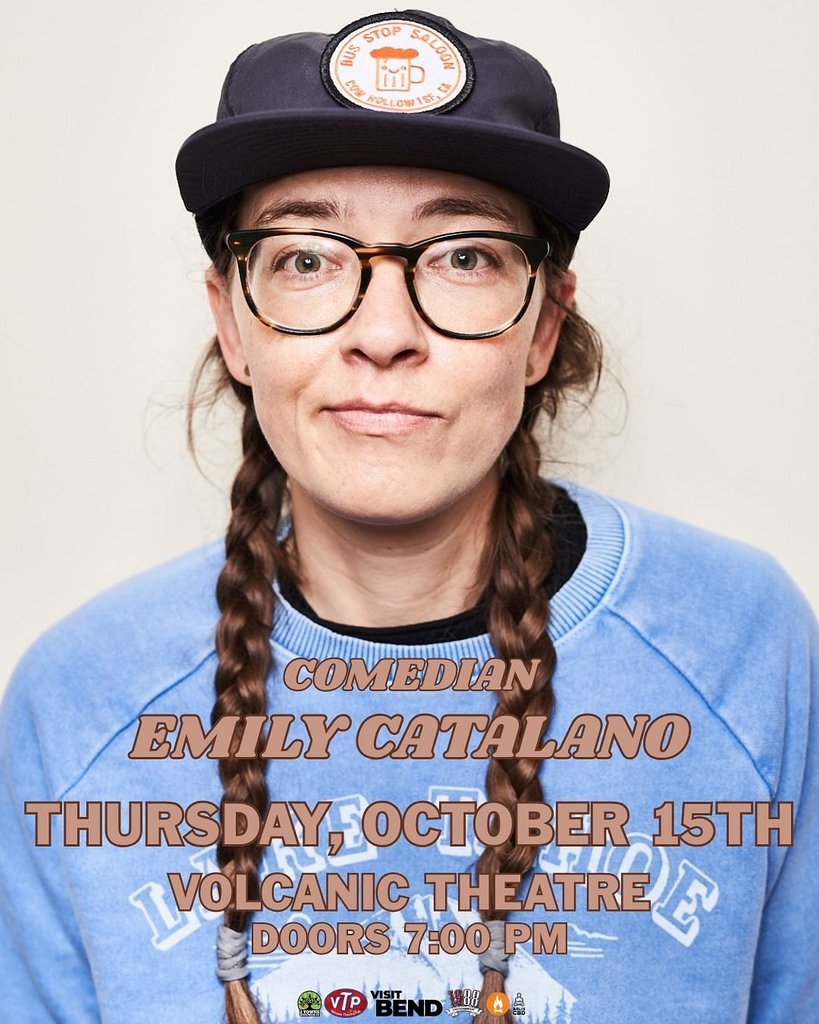 A portrait of comedian Emily Catalano wearing a baseball cap and glasses in Central Oregon.