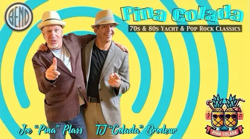Two men in fedoras and blazers pose against a yellow and blue spiral background in Central Oregon.