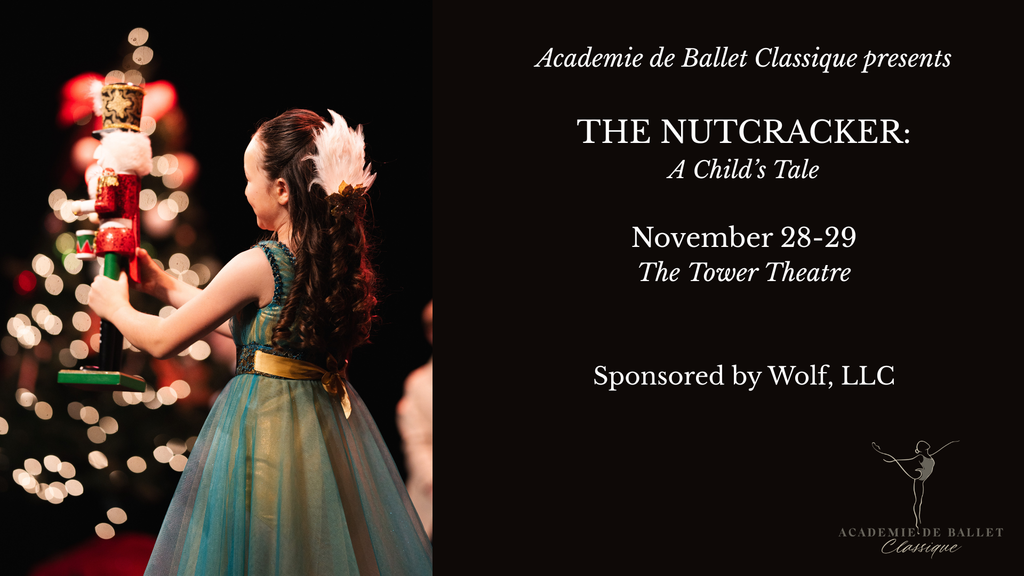 A young girl in a blue dress holds a nutcracker doll on stage in Central Oregon.