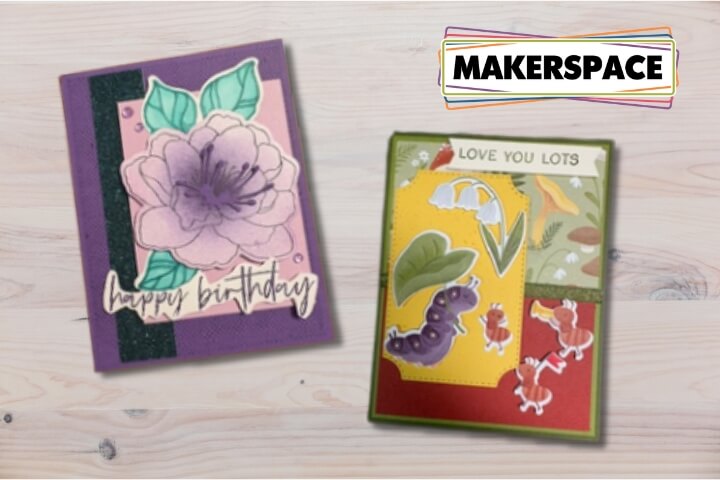 Two handmade greeting cards featuring floral and insect designs on a wooden surface in Central Oregon.