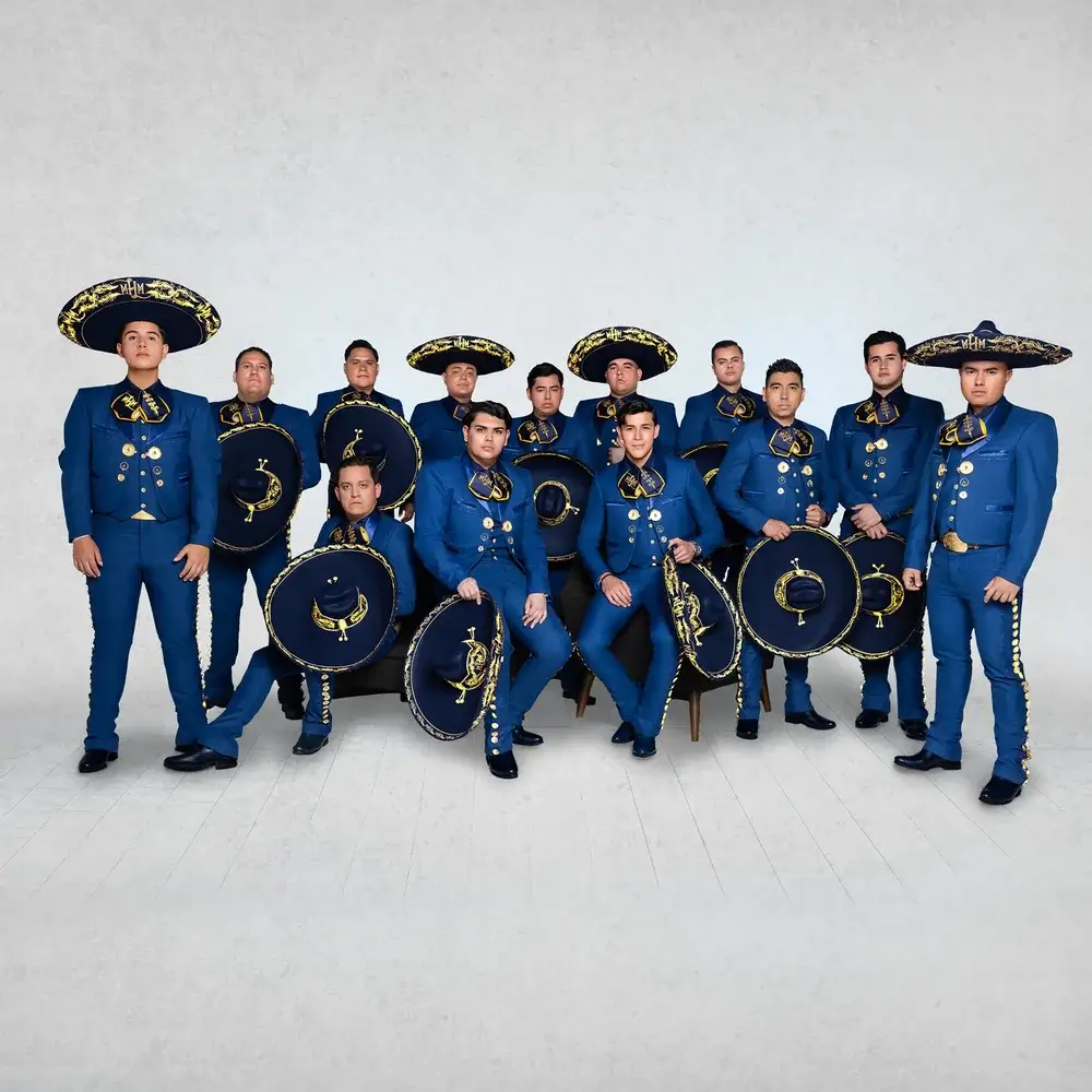 A group of thirteen men in matching blue mariachi suits posing against a white background in Central Oregon.