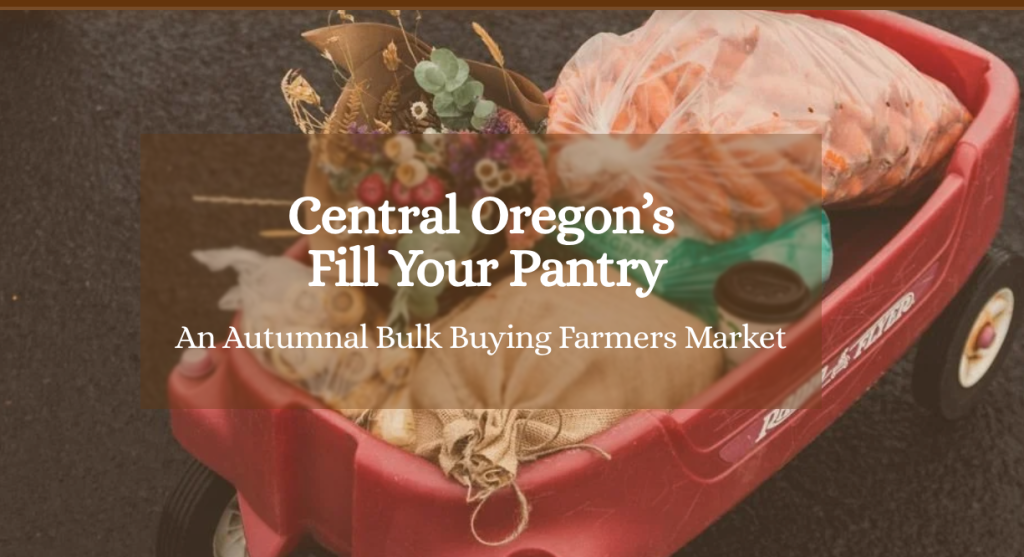 A red wagon filled with fresh produce and flowers at a farmers market in Central Oregon.