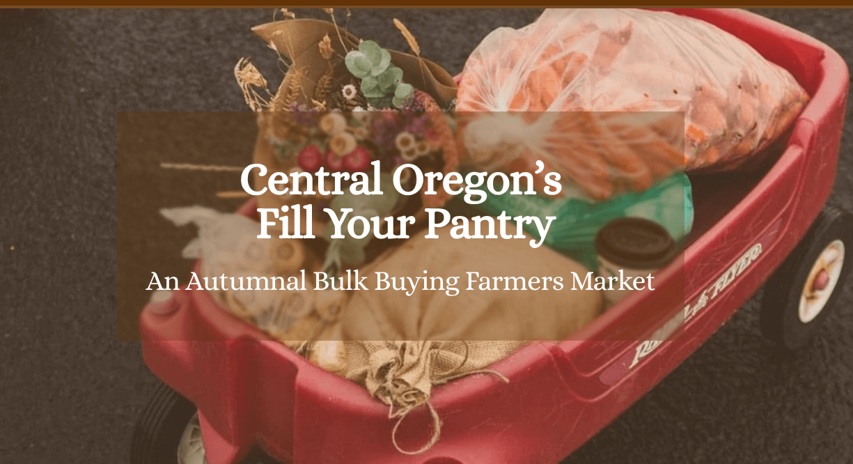 A red wagon filled with fresh produce and flowers at a farmers market in Central Oregon.