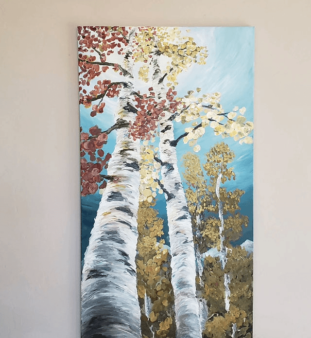An oil painting of tall birch trees with autumn leaves against a blue sky in Central Oregon.
