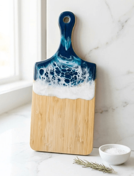 A wooden serving board with blue and white ocean-inspired resin art in Central Oregon.