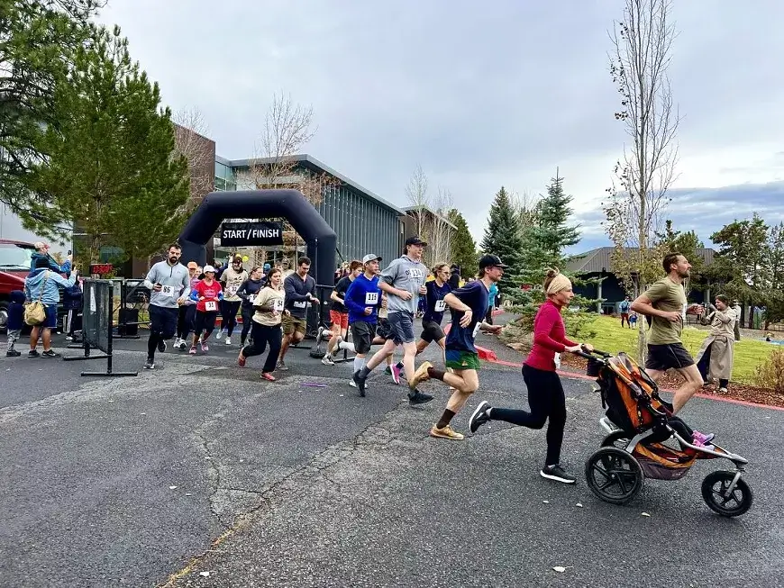 A group of people participating in a community fun run race in Central Oregon.
