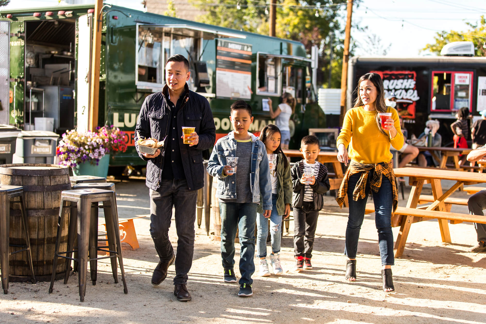 A family of five walking together at an outdoor food truck park in Central Oregon.