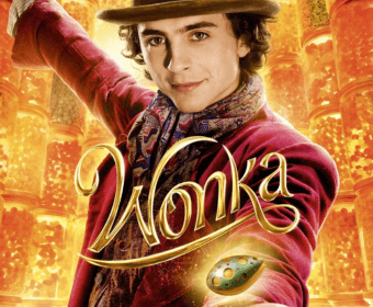 Timothée Chalamet as Willy Wonka in a red coat with a golden background in Central Oregon.